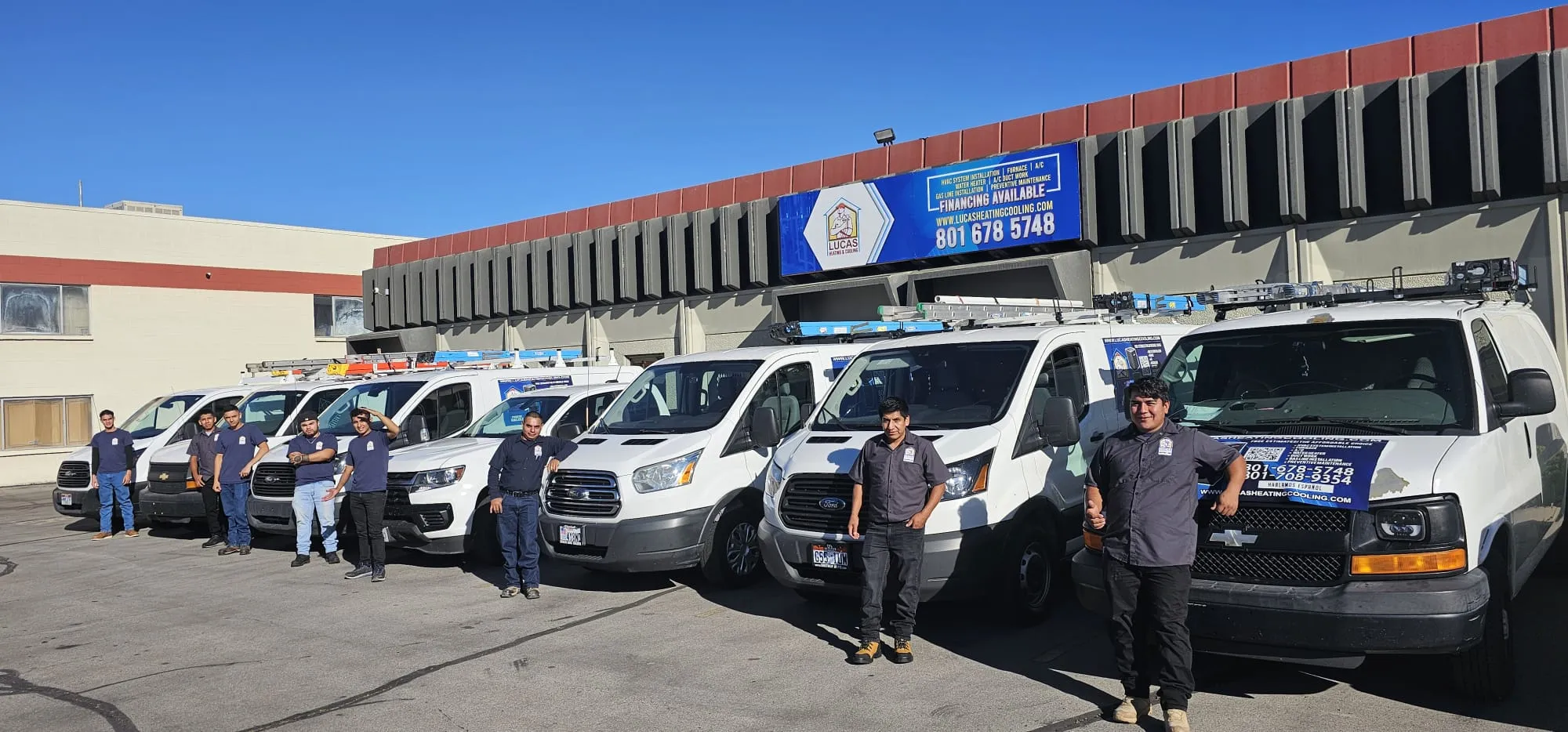 Lucas Heating and Air technicians and branded service van fleet lined up at the shop